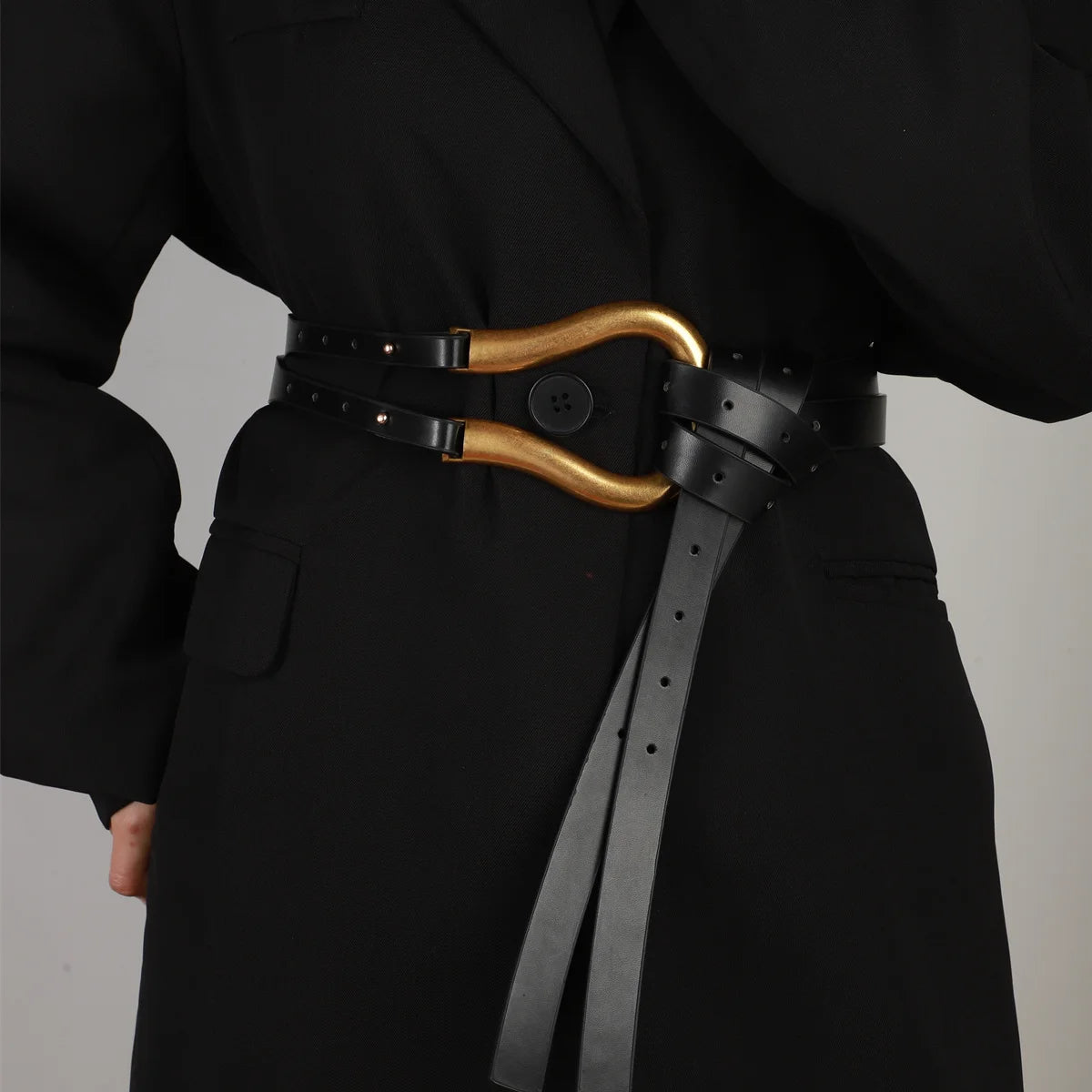 A woman's suit belt with a wide waistband large horseshoe button decoration with skirt belt